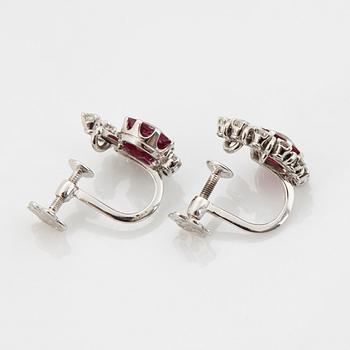 A pair of 18K white gold WA Bolin earrings set with faceted rubies and round brilliant- and eight-cut diamonds.