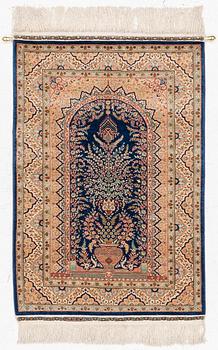 A semi-antique silk Hereke rug, West Anatolia, signed c. 107 x 72 cm.