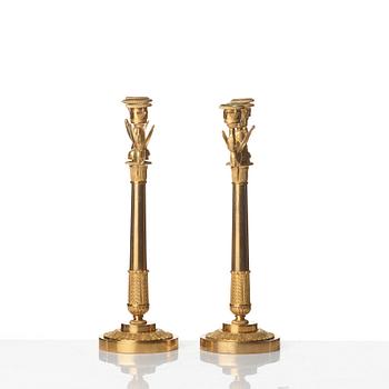 A pair of Empire early 19th century gilt bronze three-light candelabra.