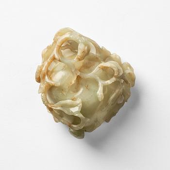 A carved Chinese nephrite cup in the shape of a lotus leaf, late Ming dynasty.