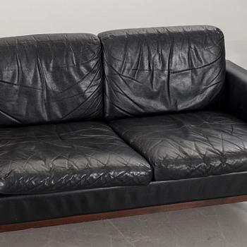 A BLACK LEATHER SOFA.