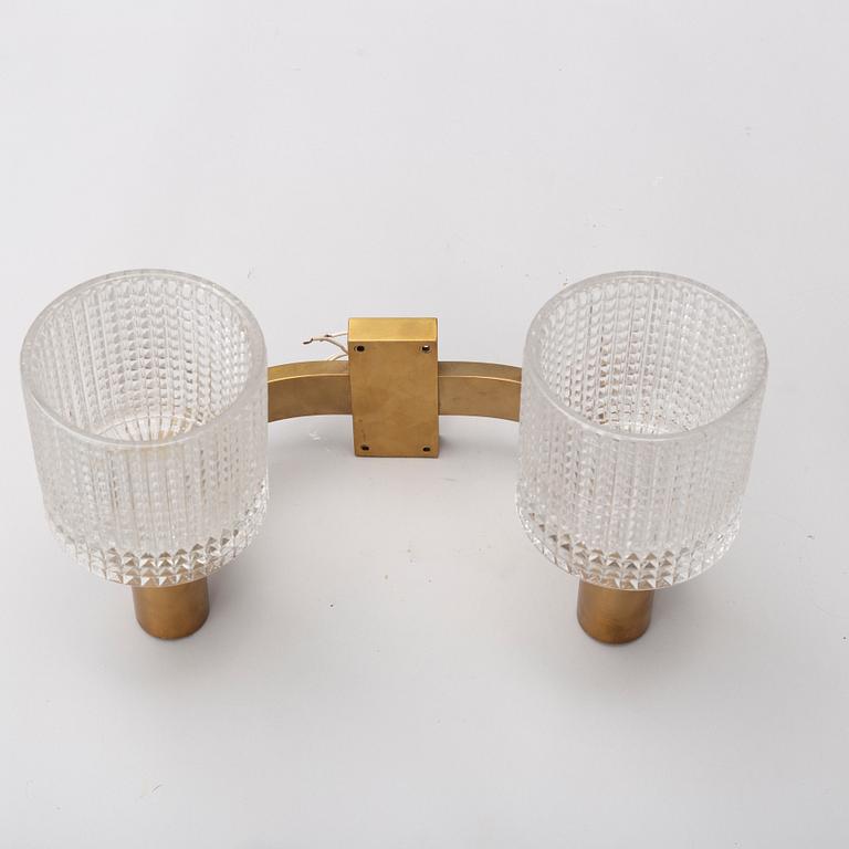 A pair of the 20th century brass and glass wall lights.