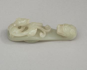 Two pale green nephrite garment hooks, Qing dynasty.
