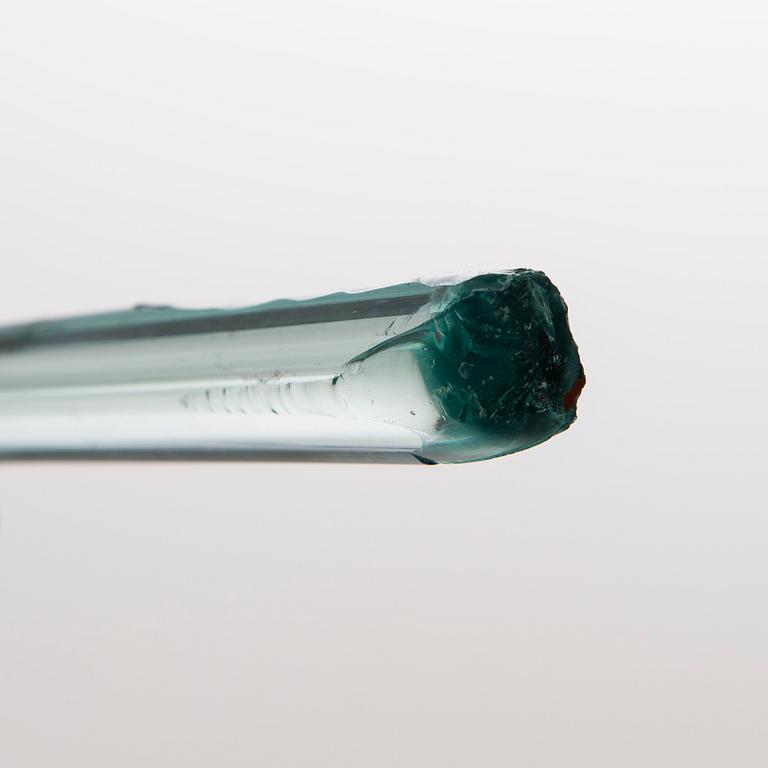A greenish glass walking stick.