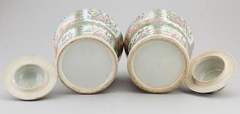 A pair of large canton famille rose vases with covers, Qing dynasty, late 19th century.