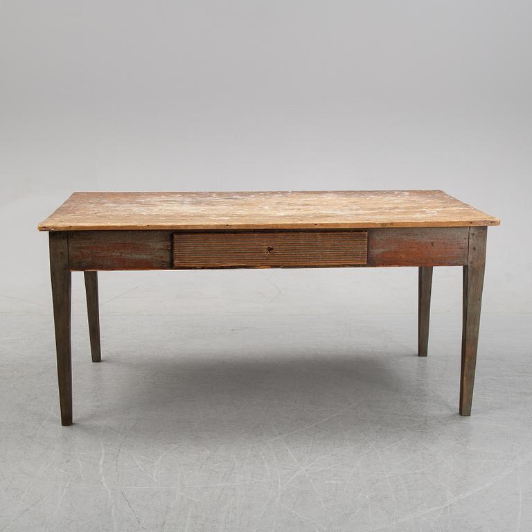 A 19th Century table with drawers.