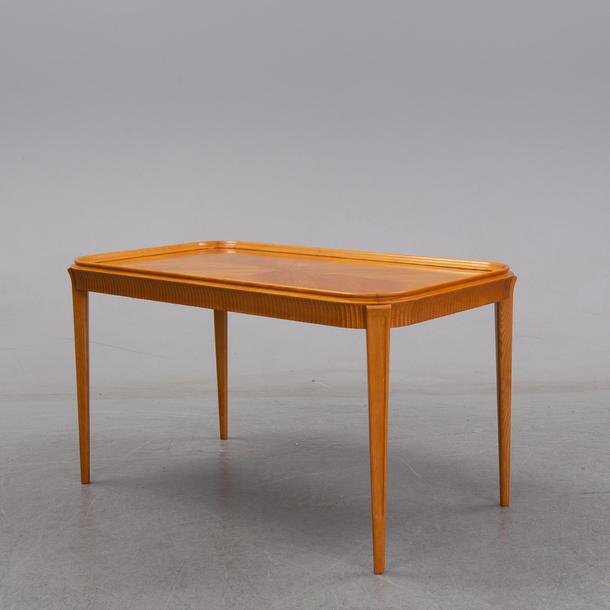 An elm Swedish Modern coffee table, dated 11 11 1947.