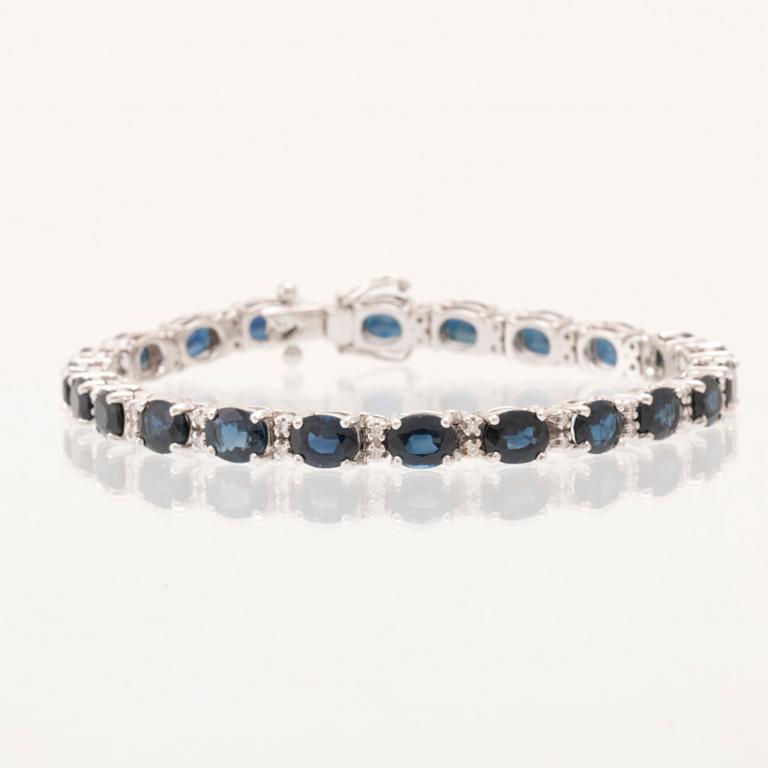 An 18K white gold bracelet set with oval faceted sapphires and round brilliant-cut diamonds.