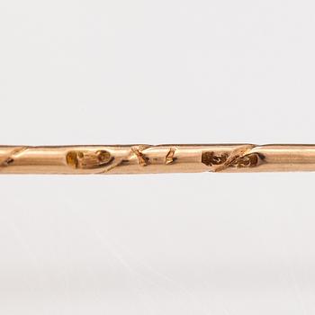 A 14K gold tiepin with a aquamarine.