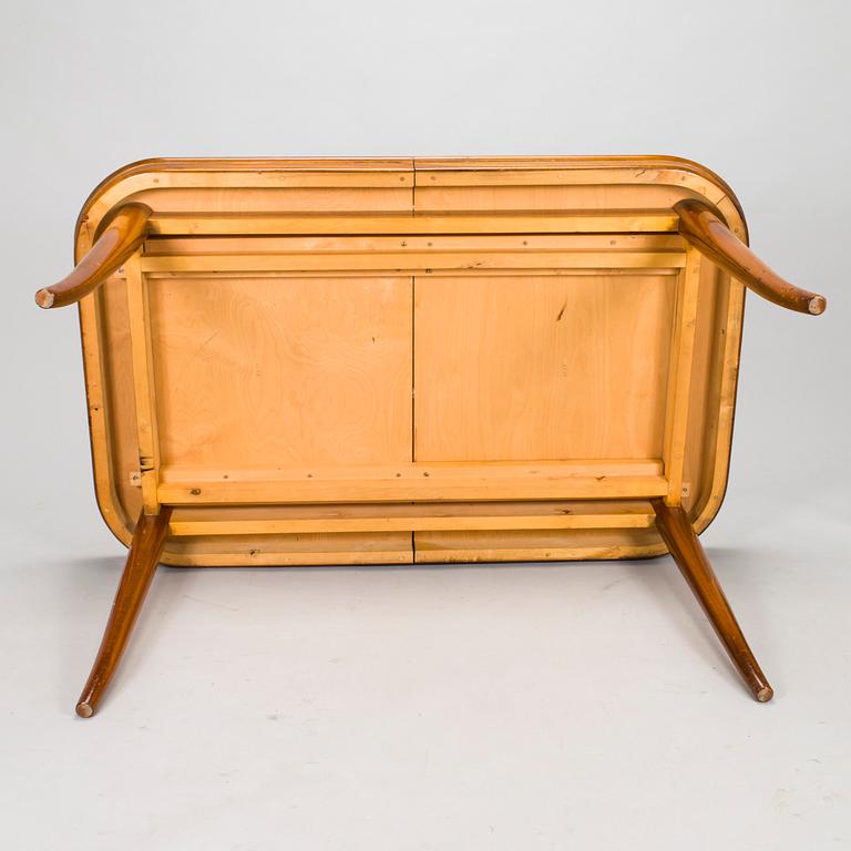 A mid 20th century dining table and a set of four chairs, Oy Boman Ab and two chairs Werner West.