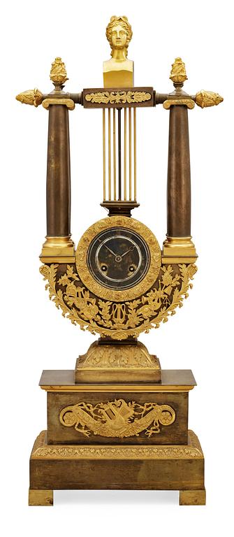A French Empire early 19th century patinated and gilt bronze mantel clock.