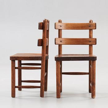 A pair of Axel Einar Hjorth stained pine 'Sandhamn' chairs.