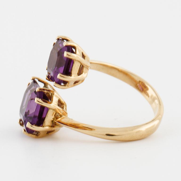 A emerald cut amethyst ring.