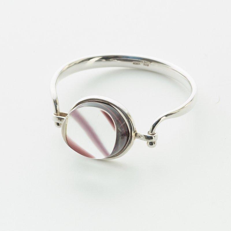 A Torun Bülow Hübe sterling bangle with a cut graal glass lock, ca 2001.