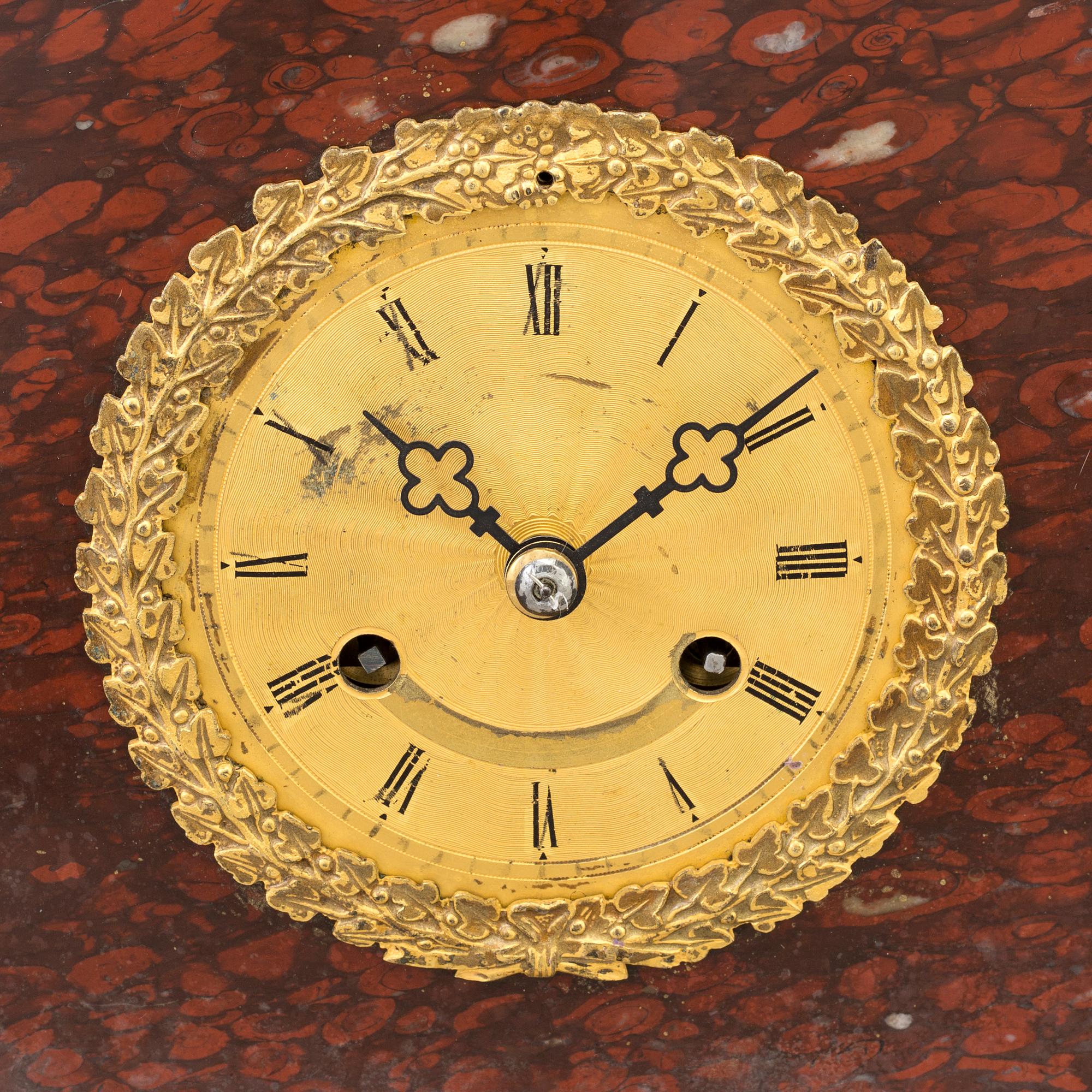 AN EMPIRE ORMOLU AND MARBLE MANTEL CLOCK, first half of the 19th century.