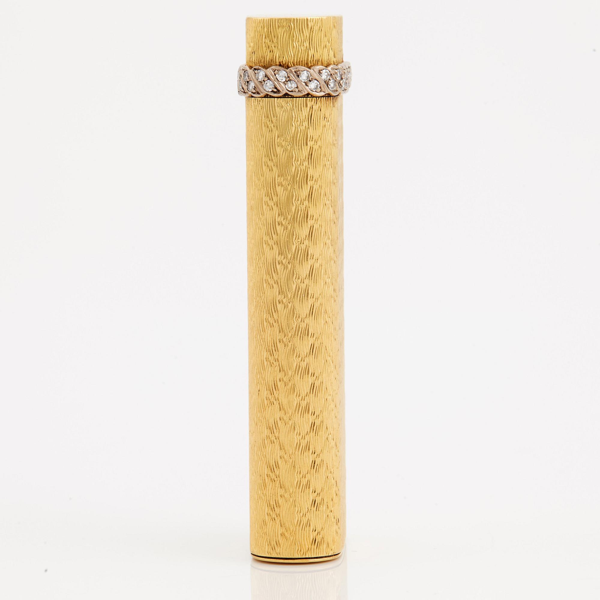 A cigarette lighter by Cartier set with single cut diamonds.