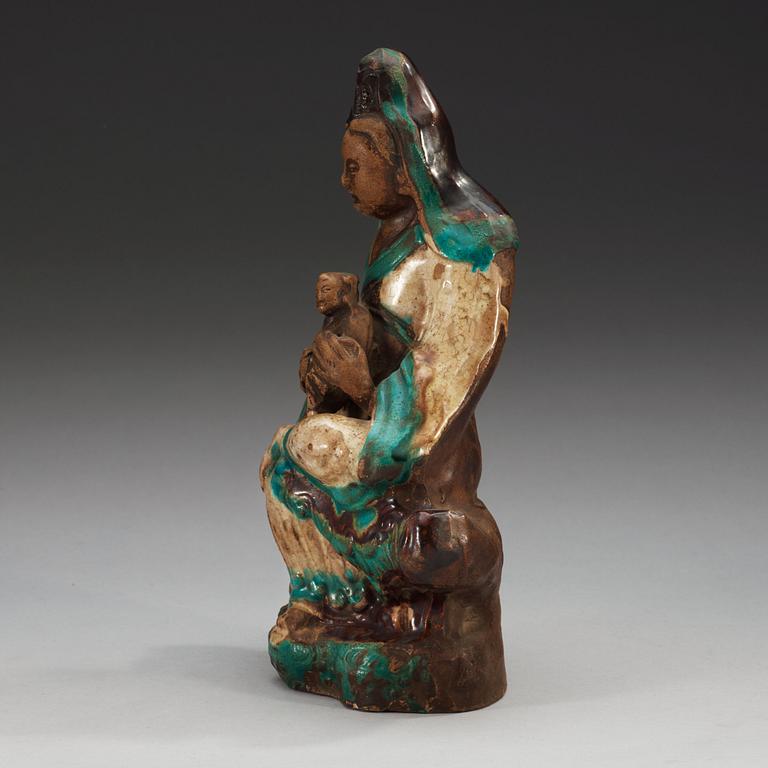 A turquoise, aubergine and white glazed figure of Guanyin, Ming dynasty (1368-1644).