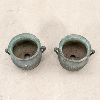 Outer casings/urns, a pair from the first half of the 20th century, cast iron.