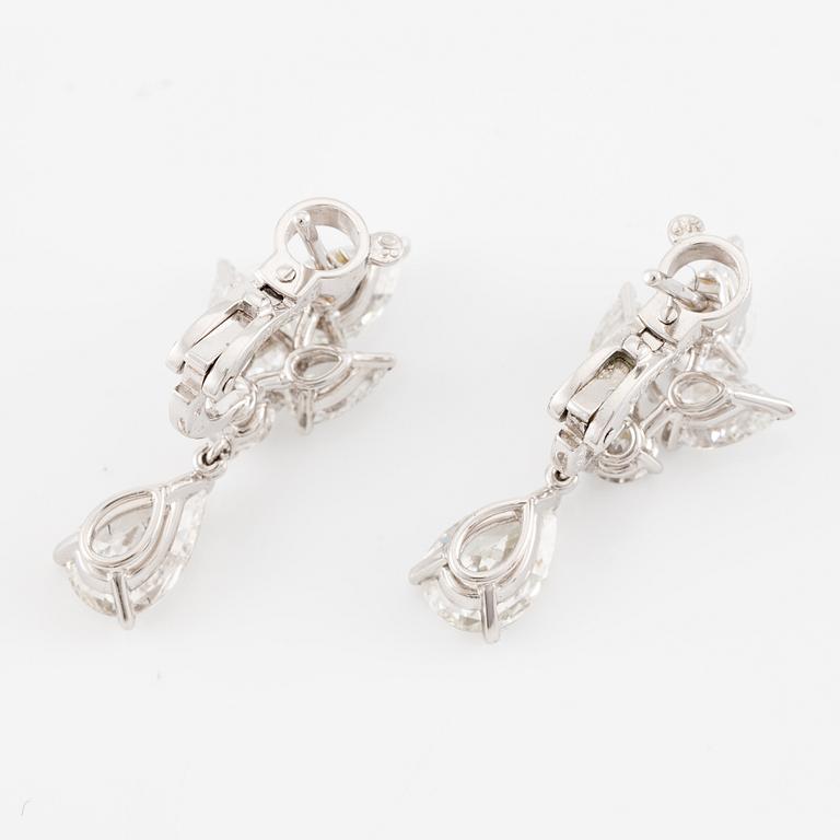 Cartier a pair of earrings platinum set with drop-shaped and round brilliant-cut diamonds.