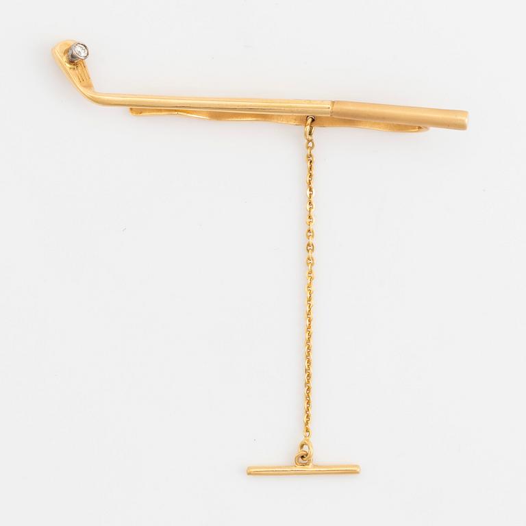 Slipsnål, 18K guld med briljantslipad diamant, i form av en golfklubba.