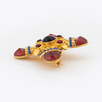 Gianni Versace, a gold tone and glass stone brooch.