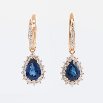 Pear shaped sapphire and brilliant cut diamond earrings.