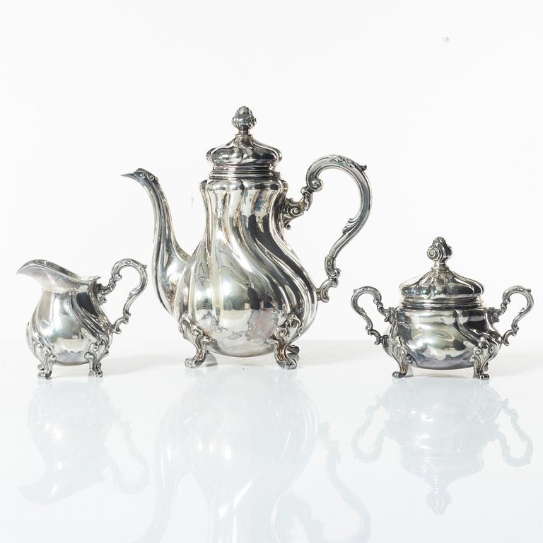 A Norwegian silver Rococo style coffee pot, cream jug, and sugar bowl, Norsk Filigransfabrikk, Oslo circa 1920.
