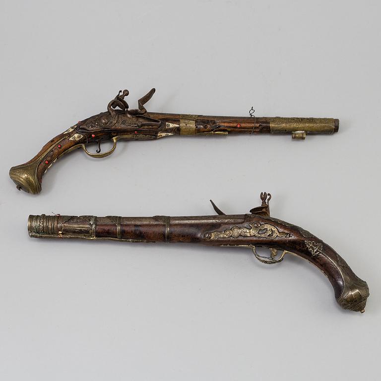 Two 19th century flintlock pistols.