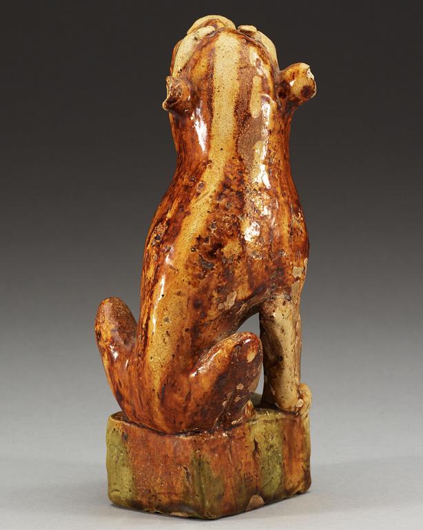 A potted figure of a 'Buddhist Lion', Tang dynasty (618-907).