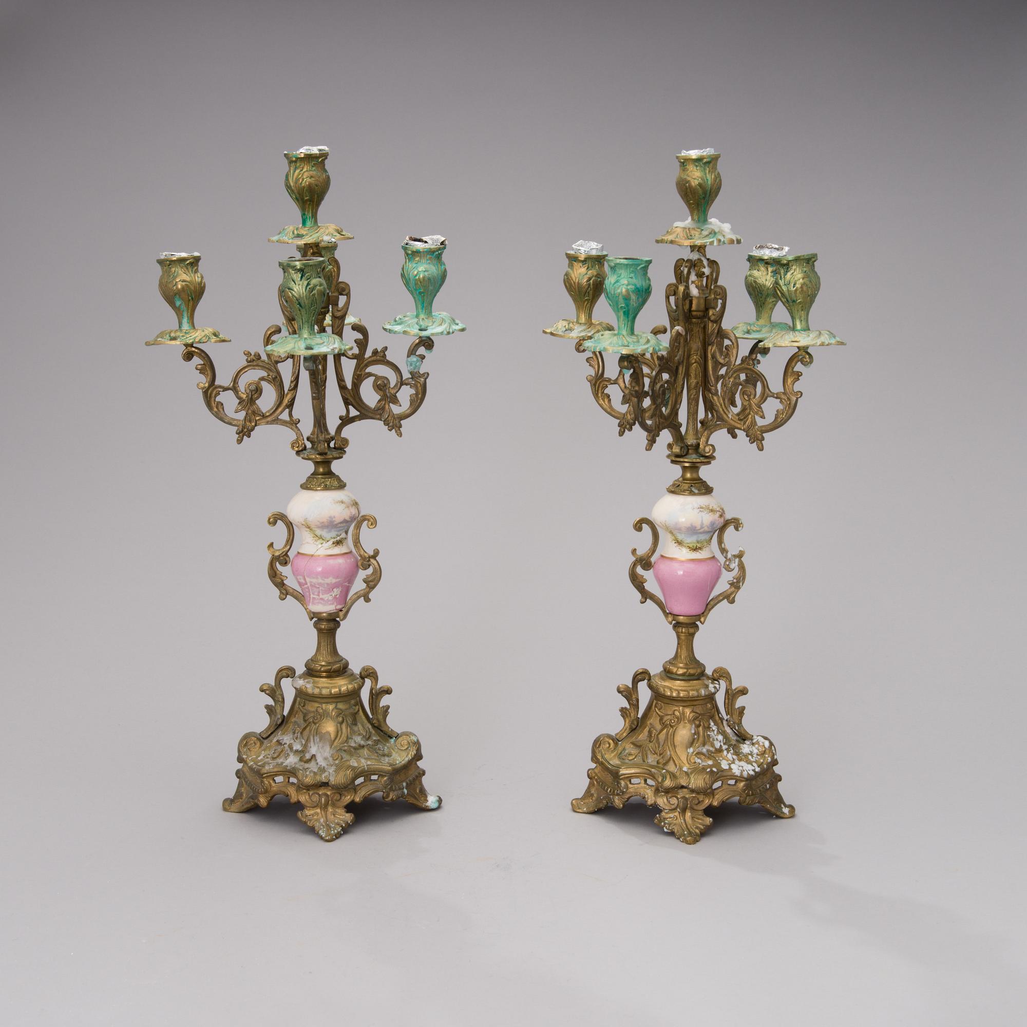 A pair of gilt-bronze Rococo Revival candelabra with porcelain decors, from the latter half of the 19th century.