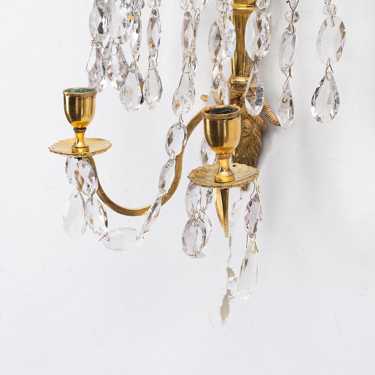 A pair of late Gustavian ormolu two-branch lustres, circa 1800.