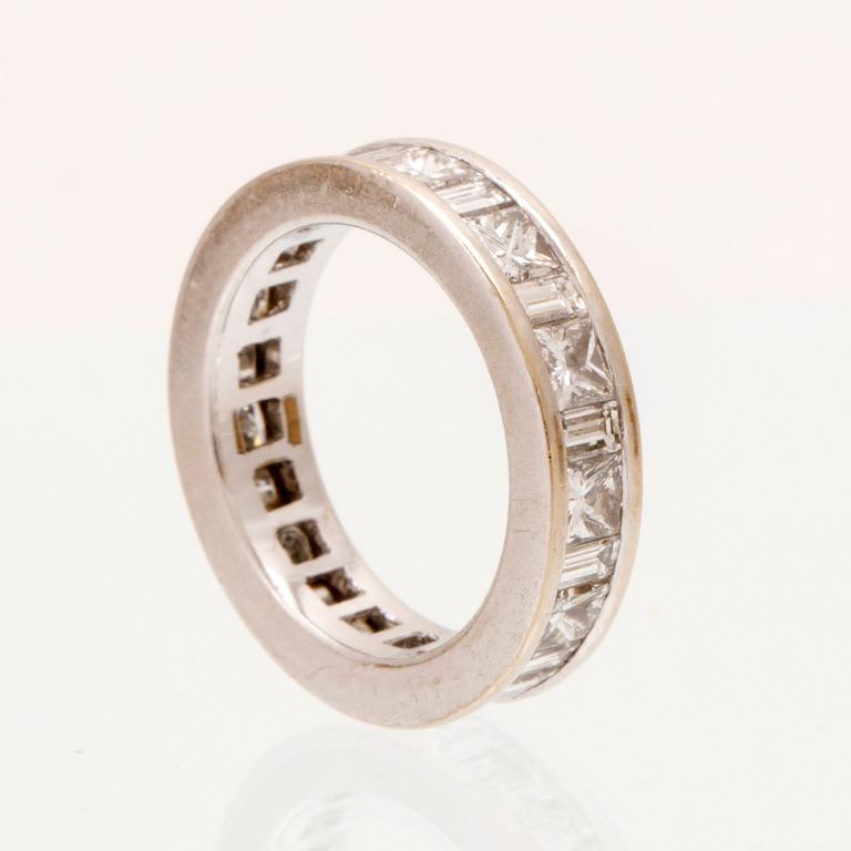 An 18K white gold eternity ring set with baguette and princess cut diamonds by Hartmann's Denmark.