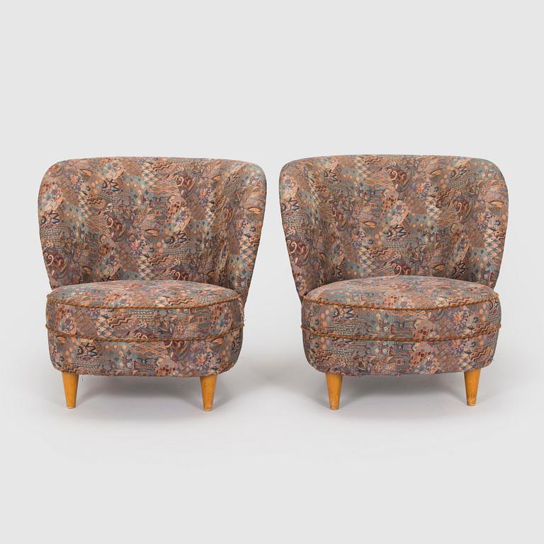 A pair of mid-20th century armchairs.