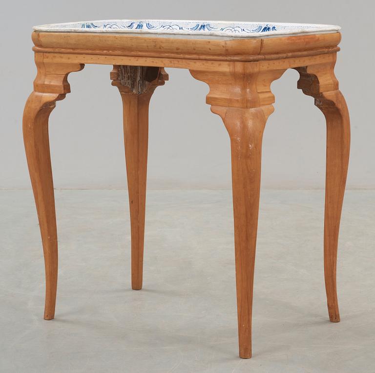 A Swedish Rococo faience tea table Rörstrand 1757.