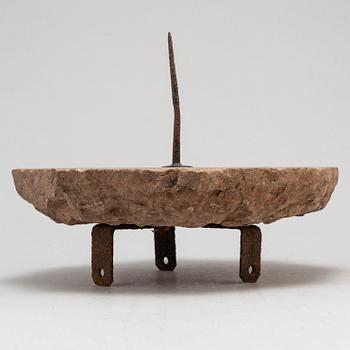 A limestone and iron sundial dated 1732.