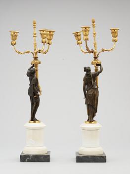 A pair of Louis XVI 18th century gilt and patinated bronze and marble three-light candelabra.