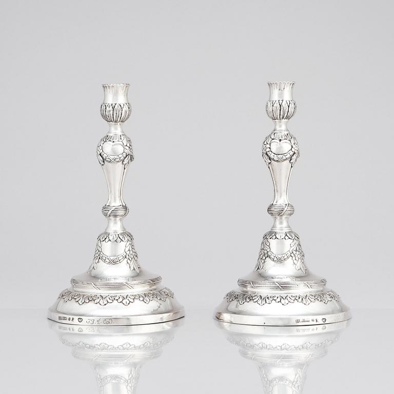 A pair of Swedish 18 century silver candelabras, mark of Lars Åkerblom Gävle 1775, arms by Christian Kullberg.