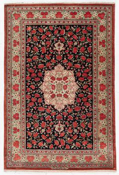 A signed silk Qum rug. c. 154 x 103 cm.