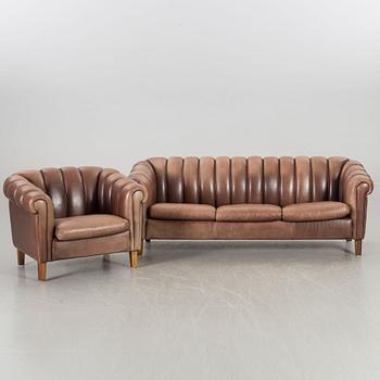 A leather sofa and armchair, 20th century latter part.