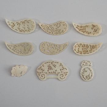 A set of nine carved white nephrite pendants and leafs, late Qing dynasty (1644-1912).