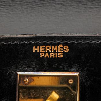 HERMÈS, a black leather bag, "Kelly 28".