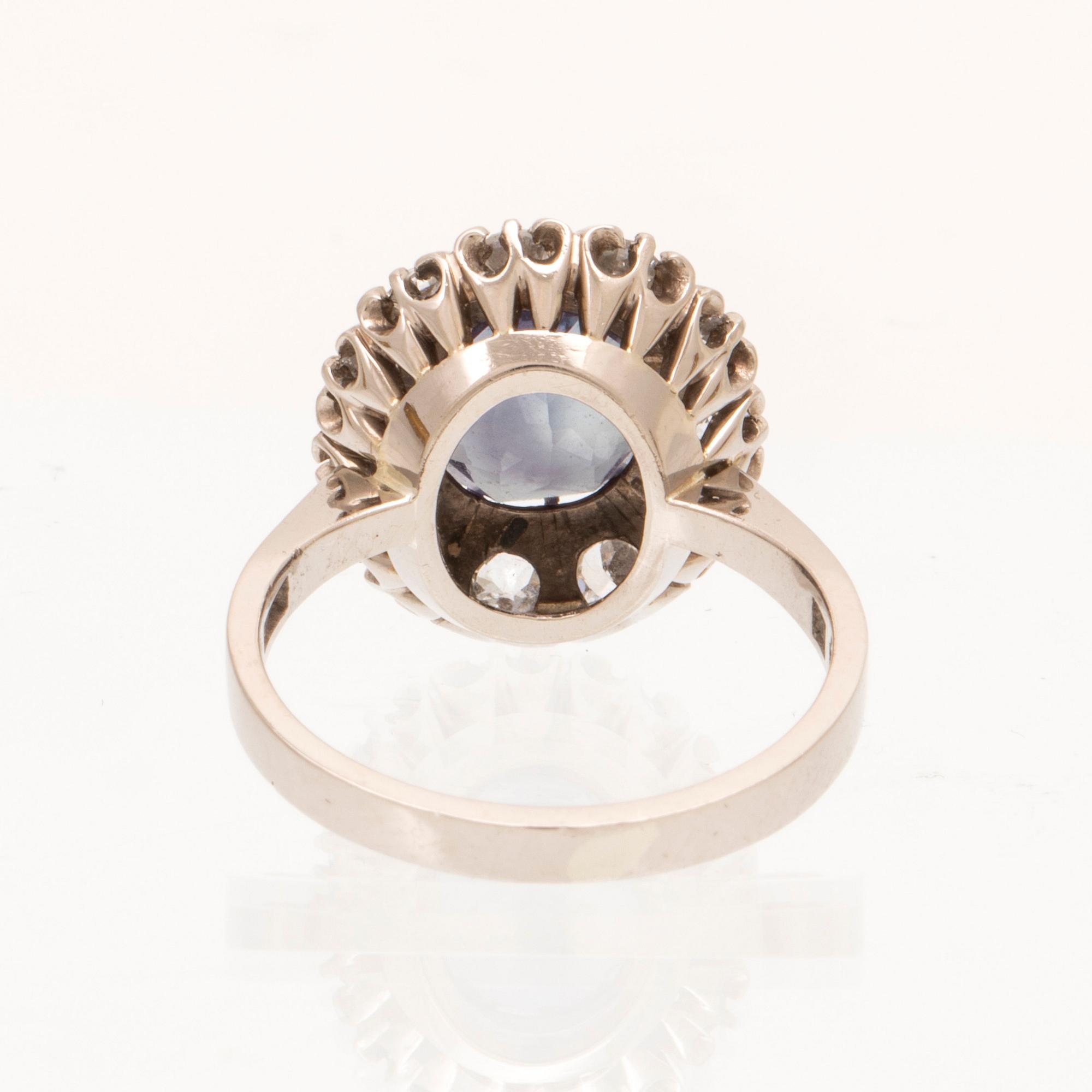 An 18K white gold ring with a colour change synthetic purple sapphire and brilliant and old cut diamonds.