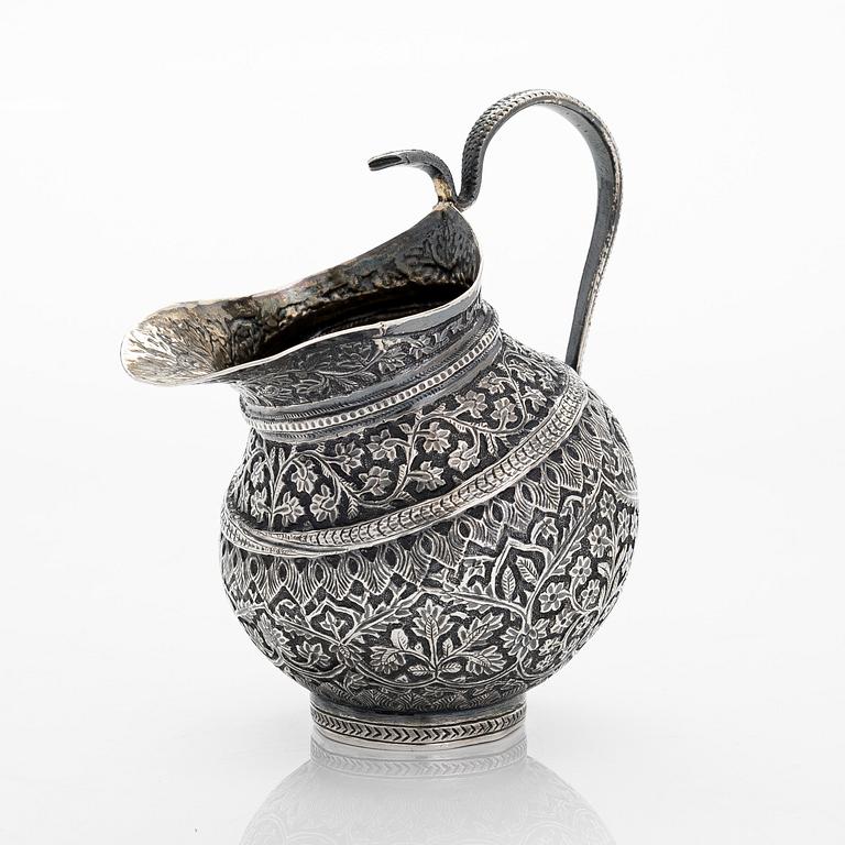 An Indian silver cream jug, and a filigree silver dish, presumably first half of the 20th century.