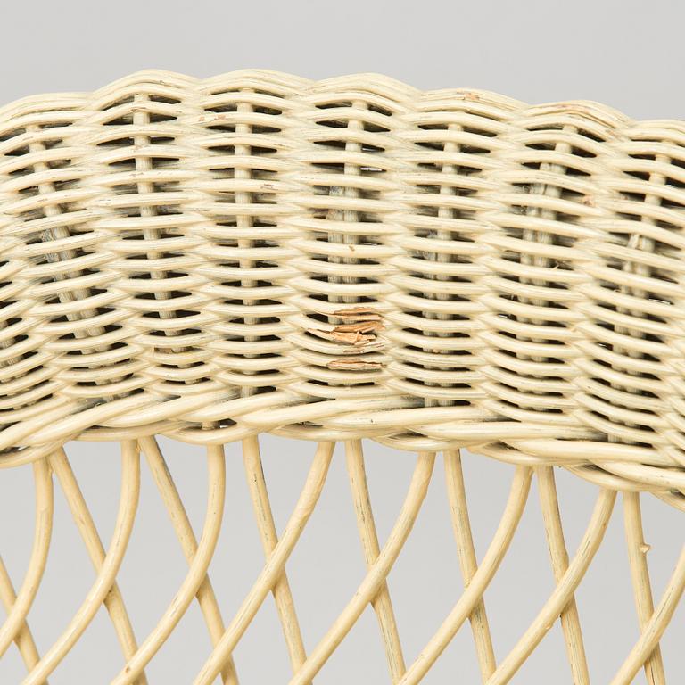 A mid-20th-century three-piece rattan furniture set including two armchairs, and a table.