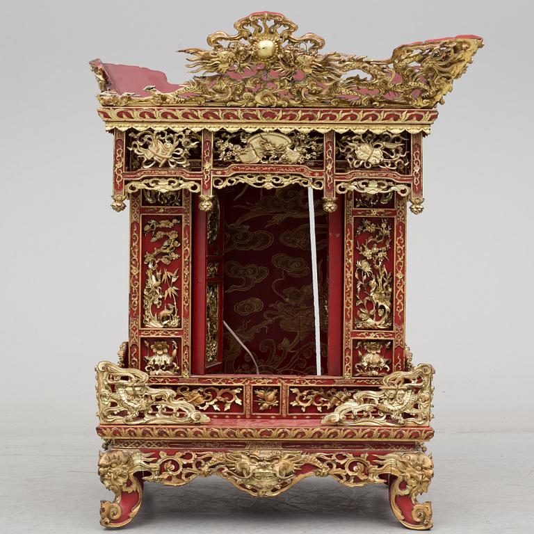 A Chinese red lacqured altar cabinet, late Qing dynasty/early 20th century.