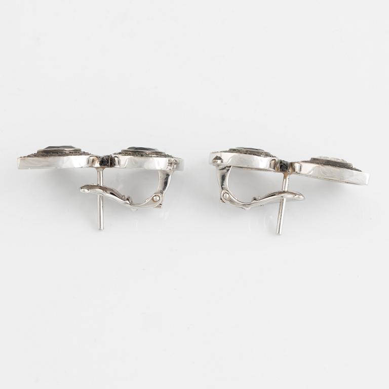 Crow's nest jewels, earrings, white gold with pear shaped diamond and black stone earrings.