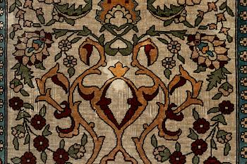 A Hereke silk rug, c. 73 x 52 cm.