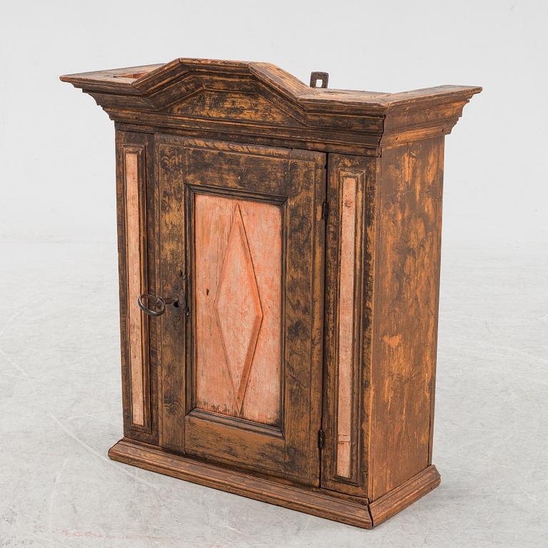 A late Baroque painted wall cabinet, dated 1757.
