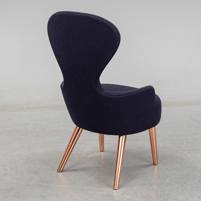 A Tom Dixon "Wingback Dining Chair" from Tom Dixon.
