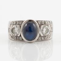 Ring in 18K white gold set with a cabochon-cut sapphire and brilliant-cut diamonds, Kenneth Magnell.